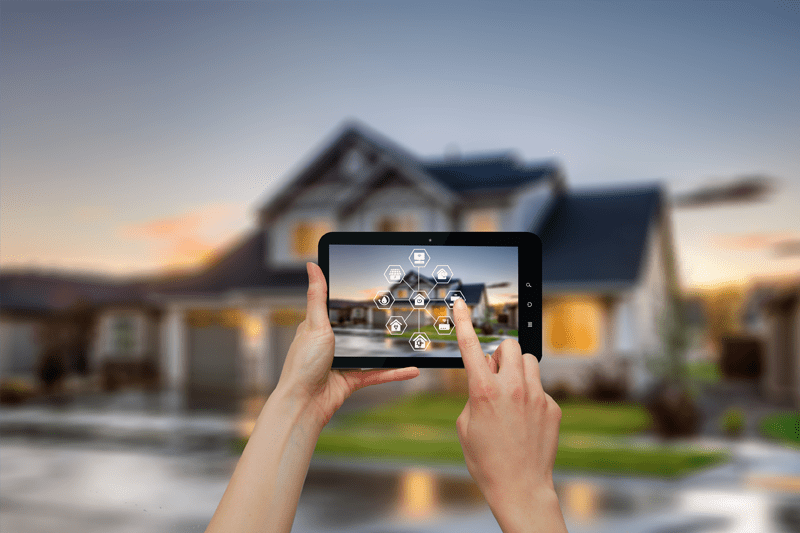 Person in front of home, checking smart home security system on mobile phone