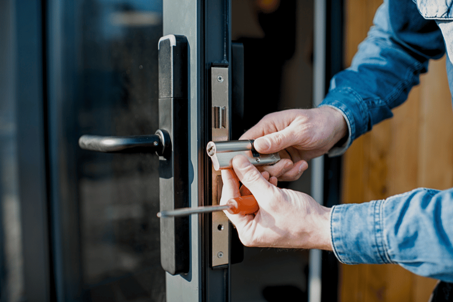 Technician installing a new door lock for security windows and doors with enhanced home security.