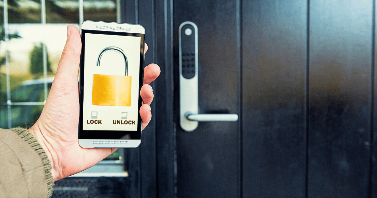 Guy locking his front door with his smartphone
