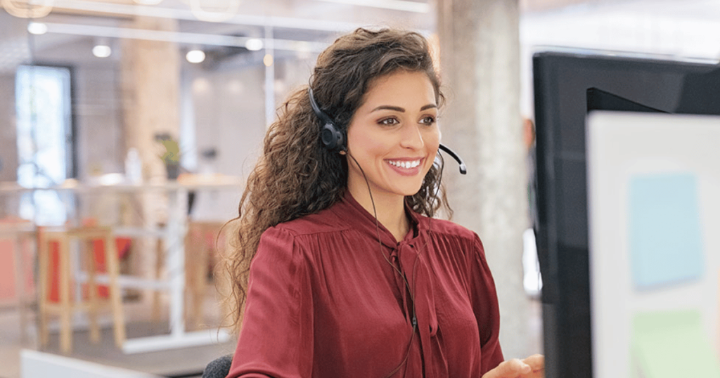 Smiling call center rep taking a security call